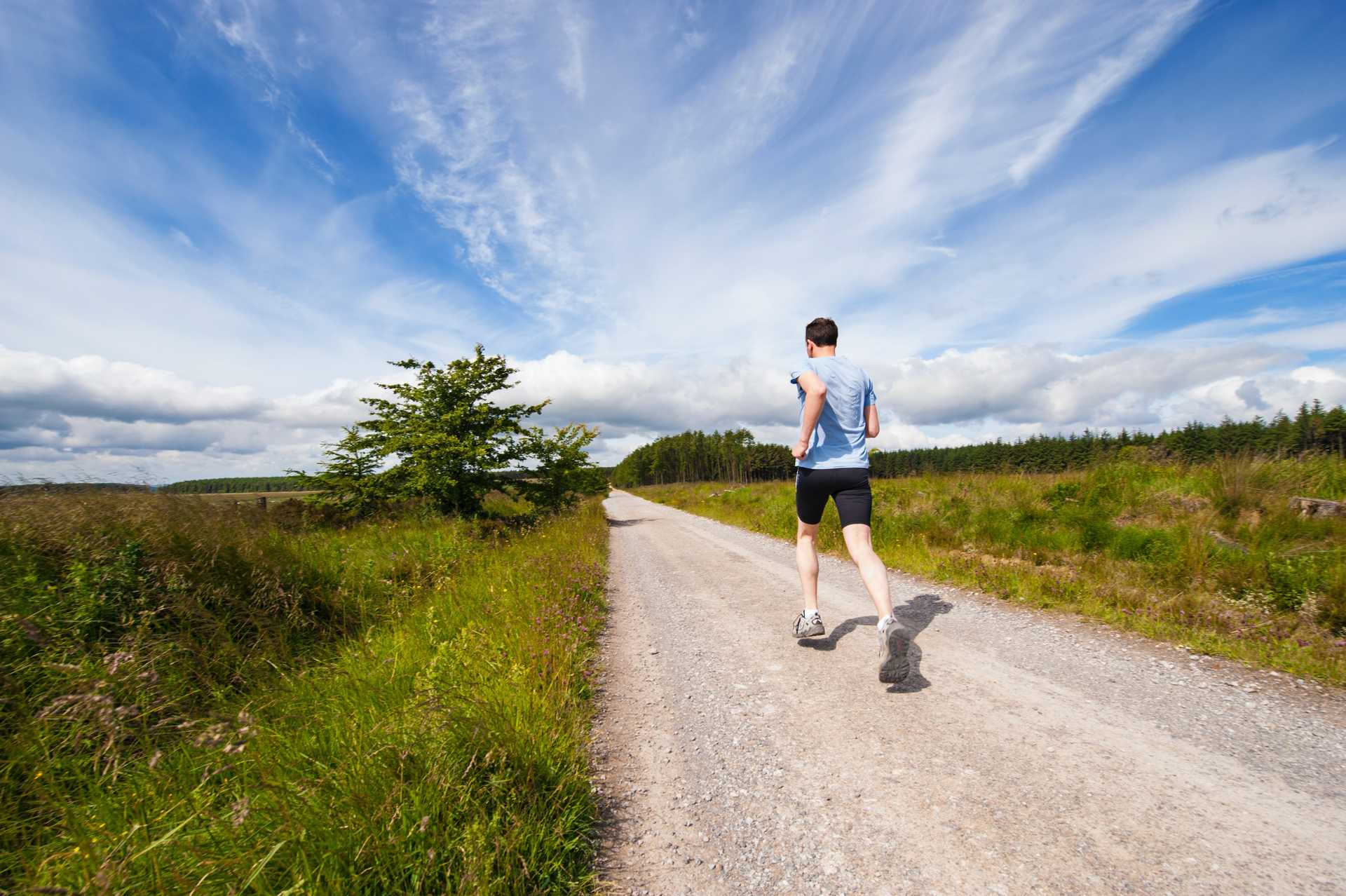 Fit runner running along dirt track